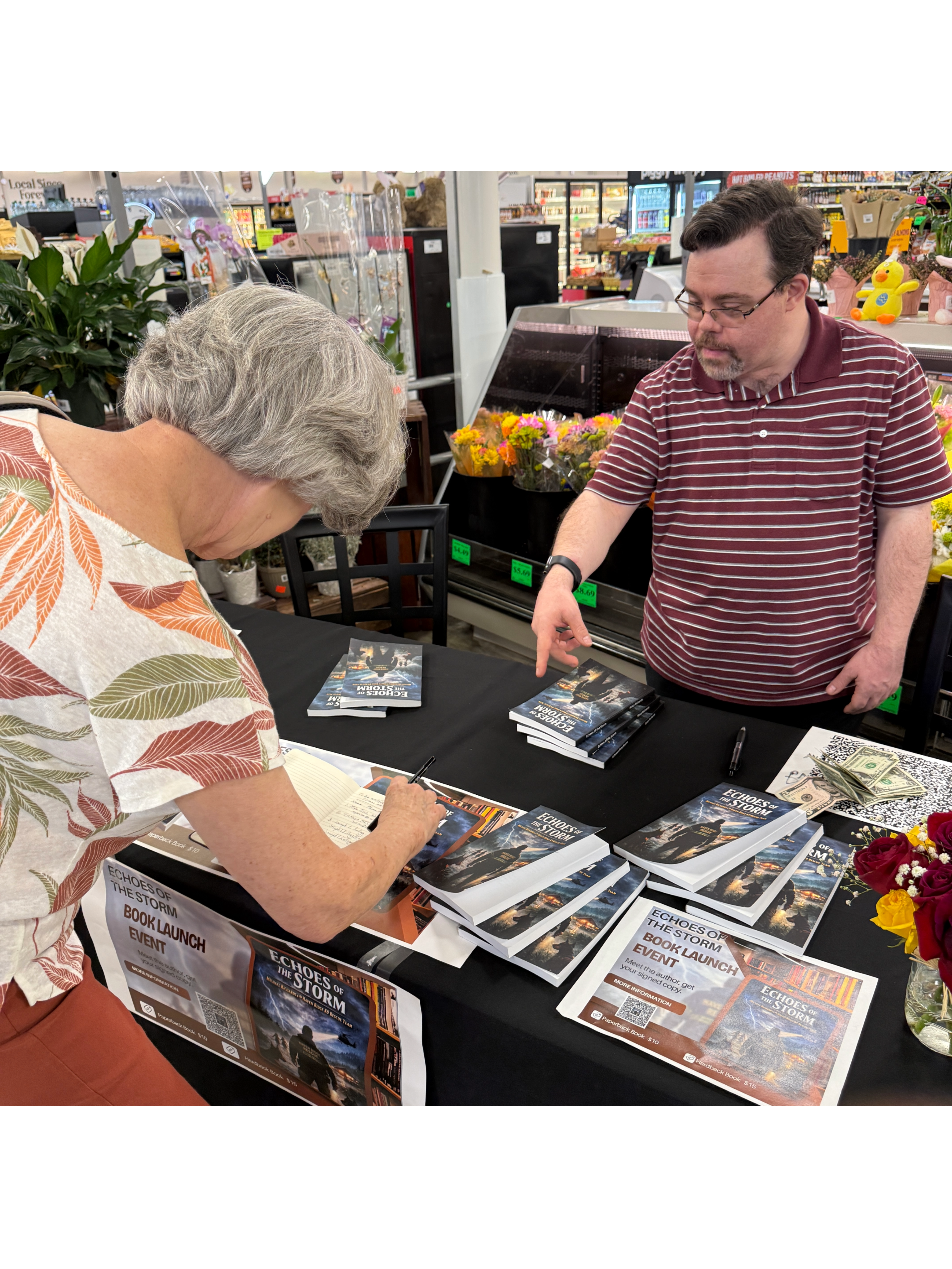 A reader browsing the Echoes of the Storm display at a book launch event